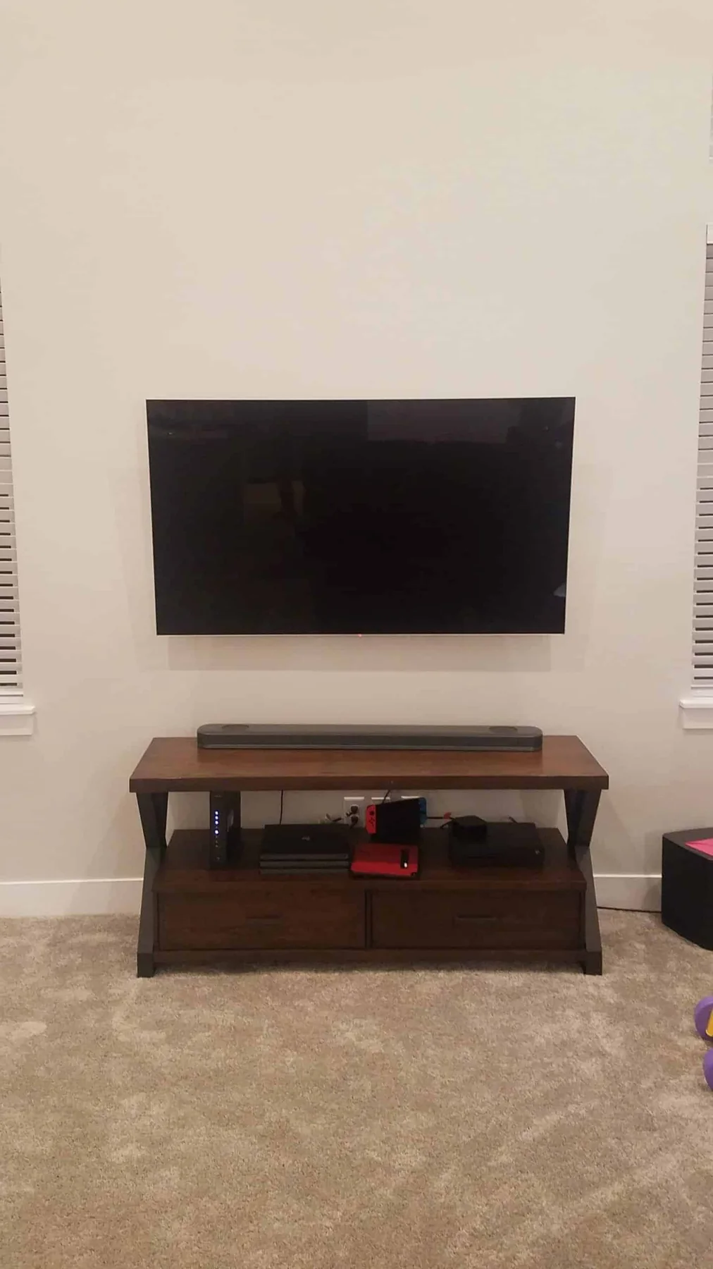 TV mounted above a low-profile media console