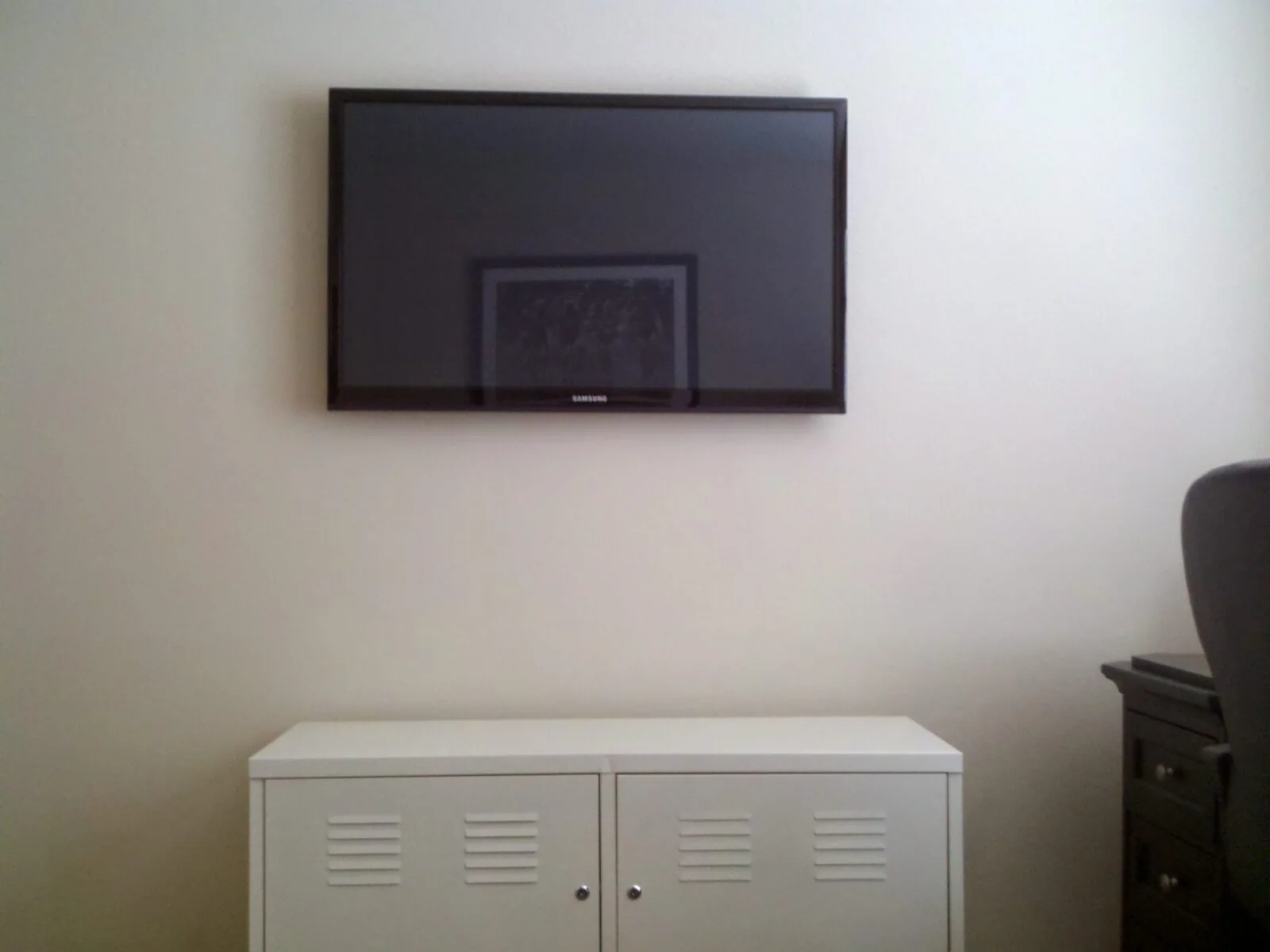 Wall-mounted TV above a clean media cabinet