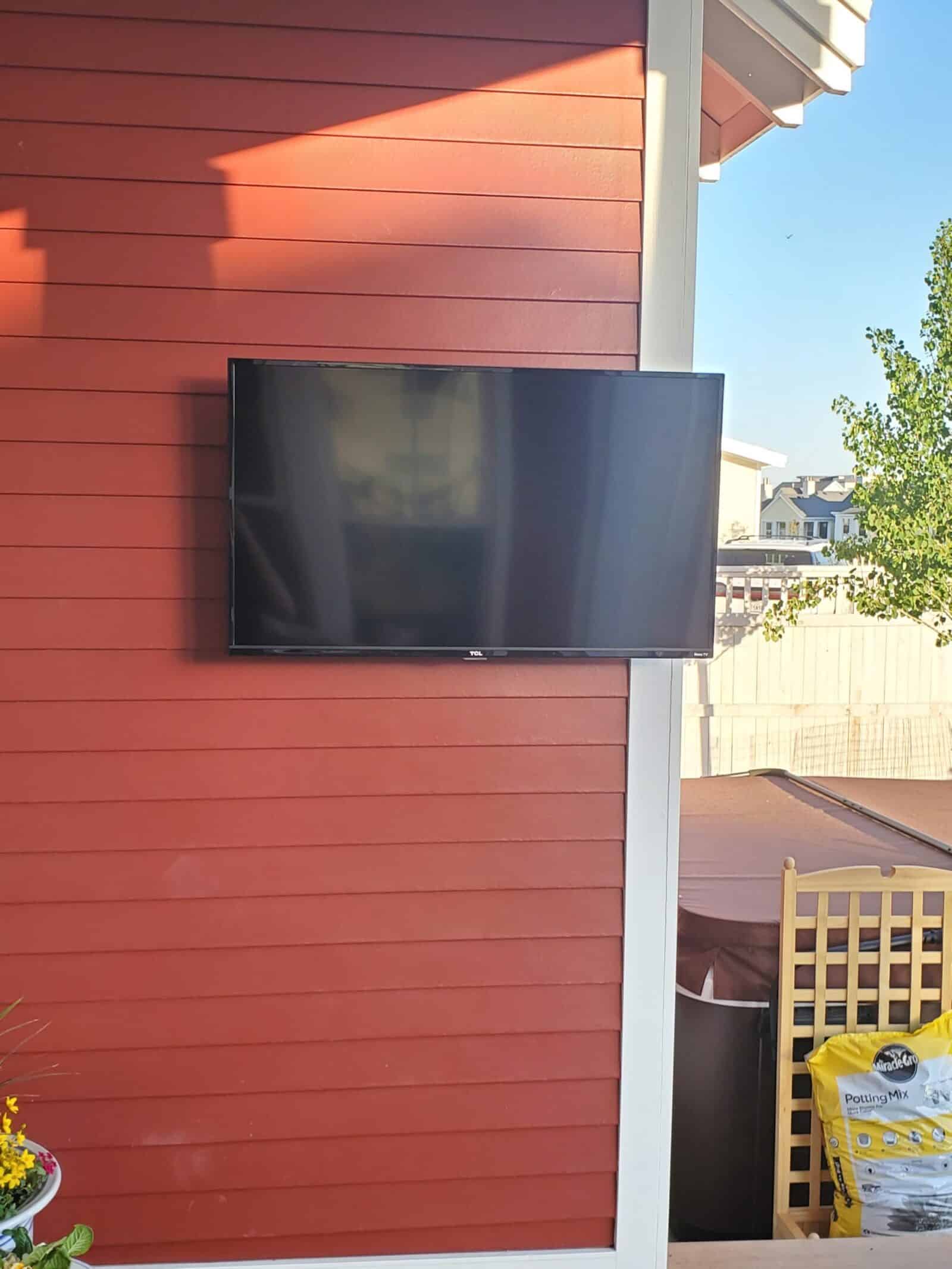 Outdoor TV mounted on a full-motion bracket