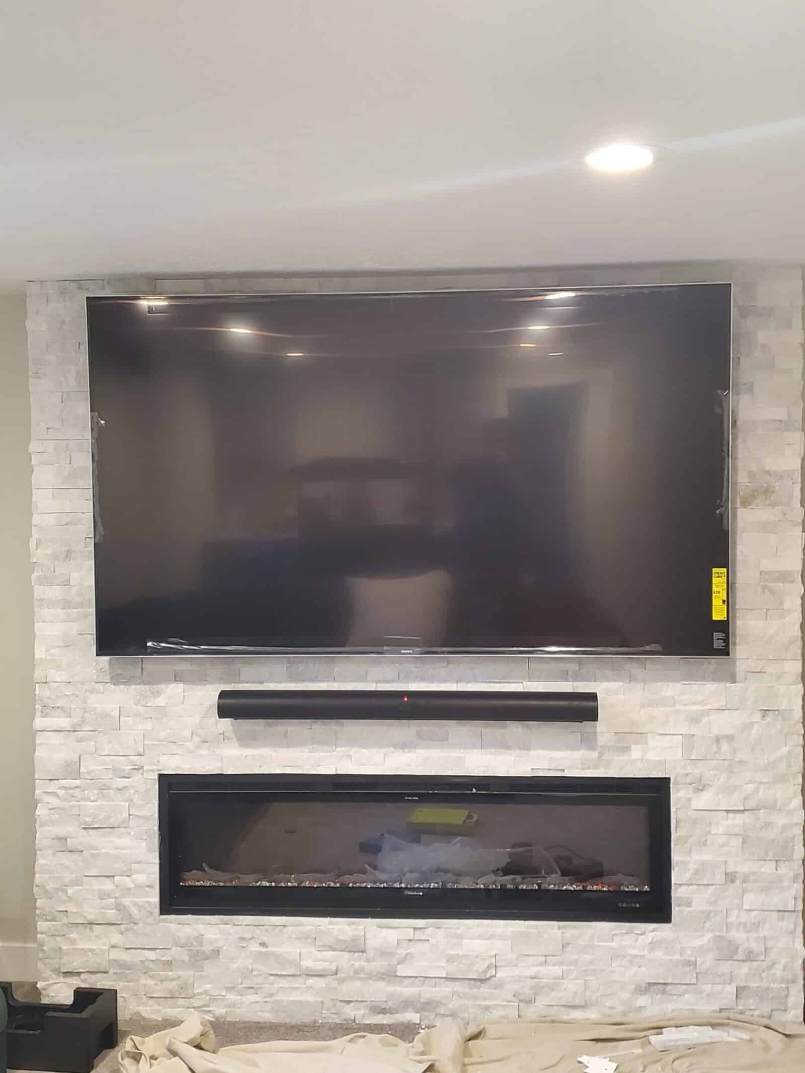 TV and soundbar aligned on a finished feature wall