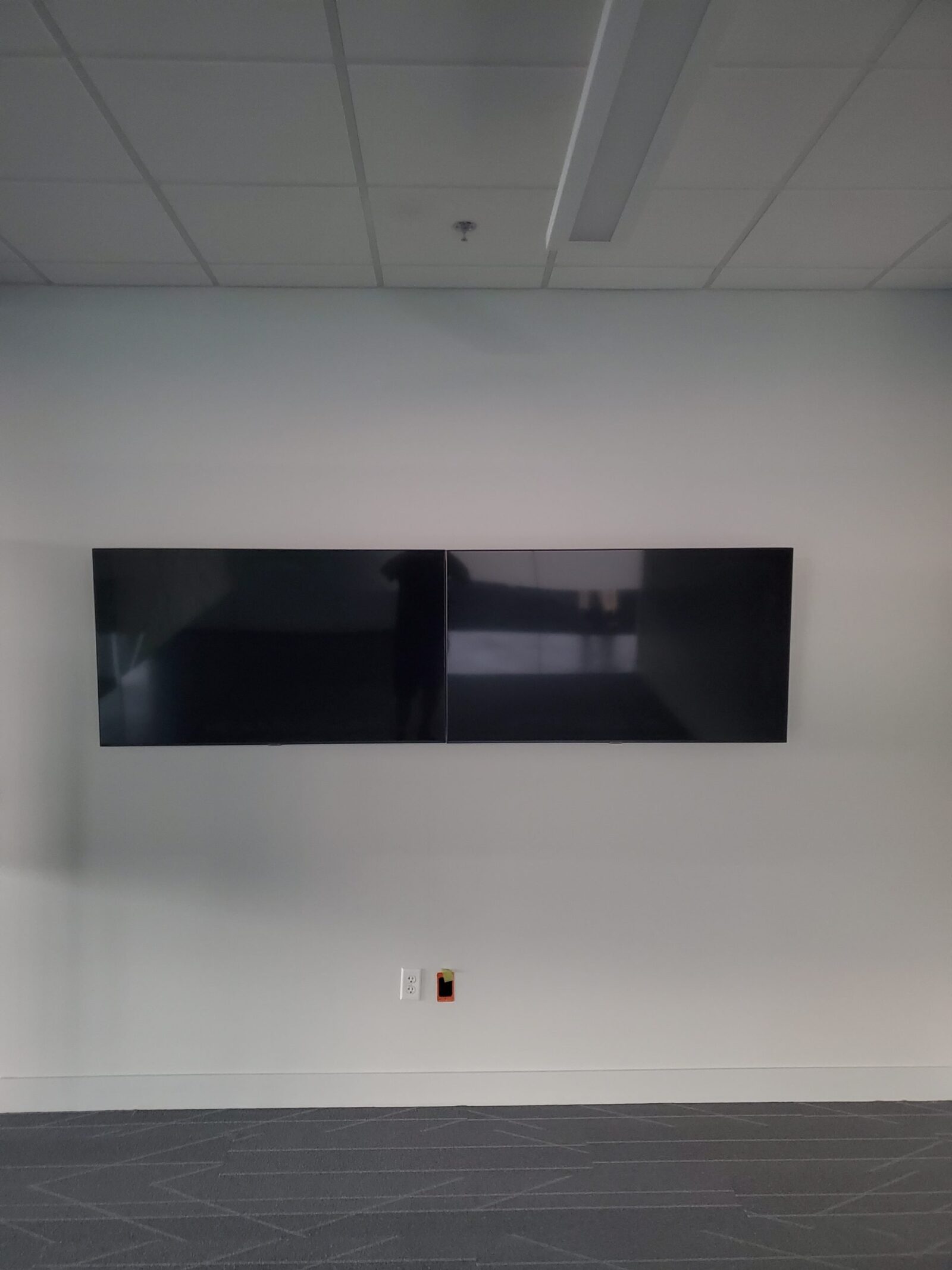 Two commercial displays mounted side by side