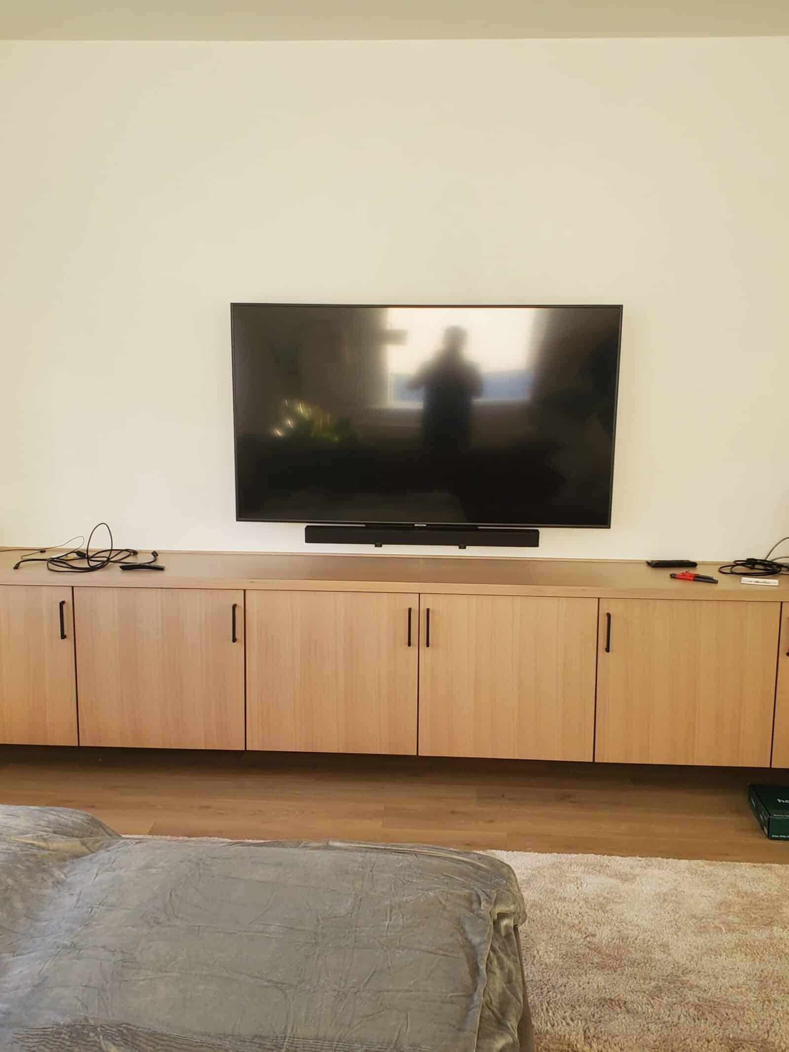 Wall-mounted TV above a media cabinet