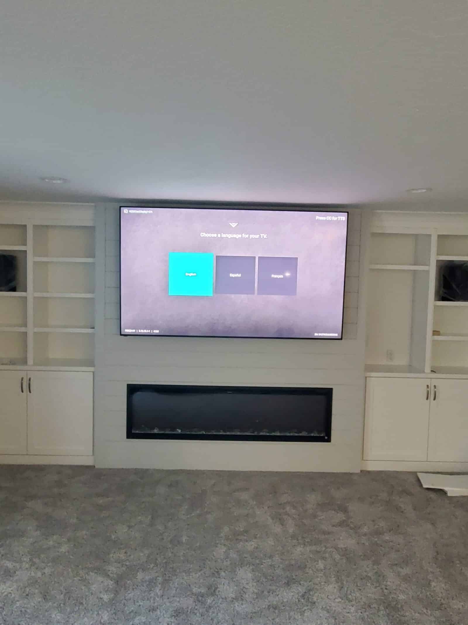 Finished television installation above a fireplace