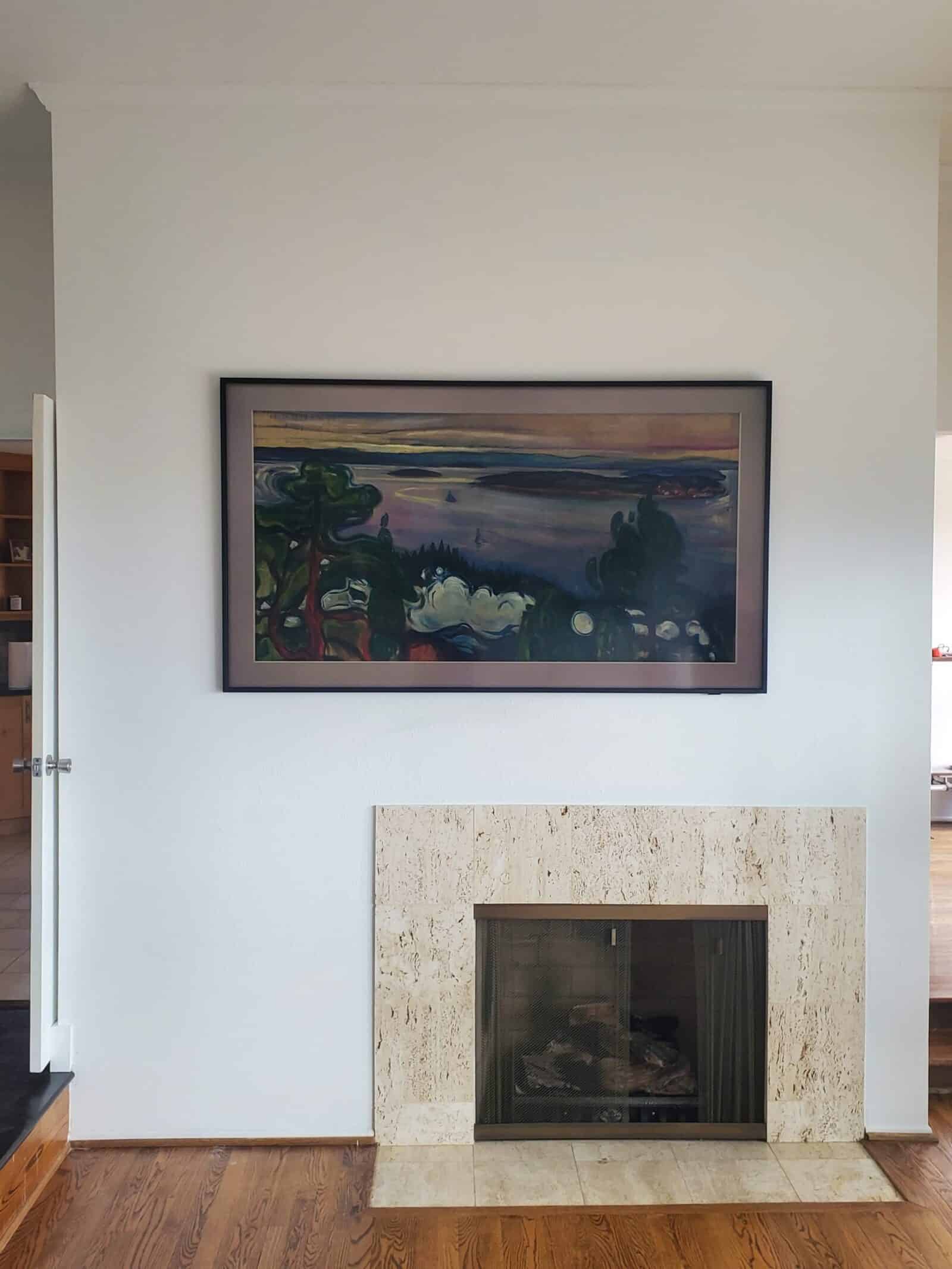 Frame-style television mounted above a fireplace